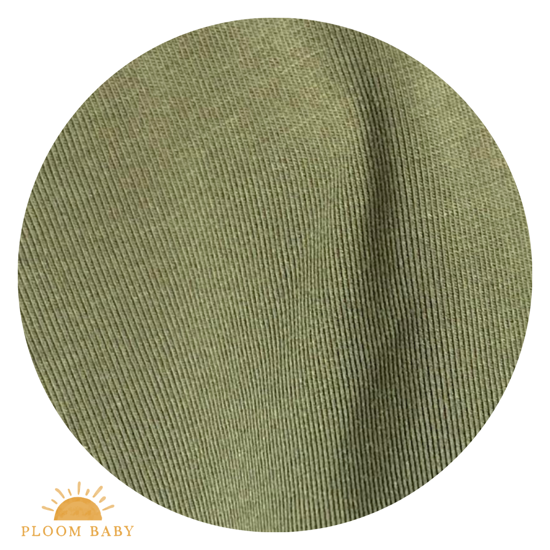 A close-up view of olive green Tencel Modal fabric with a subtle ribbed texture.