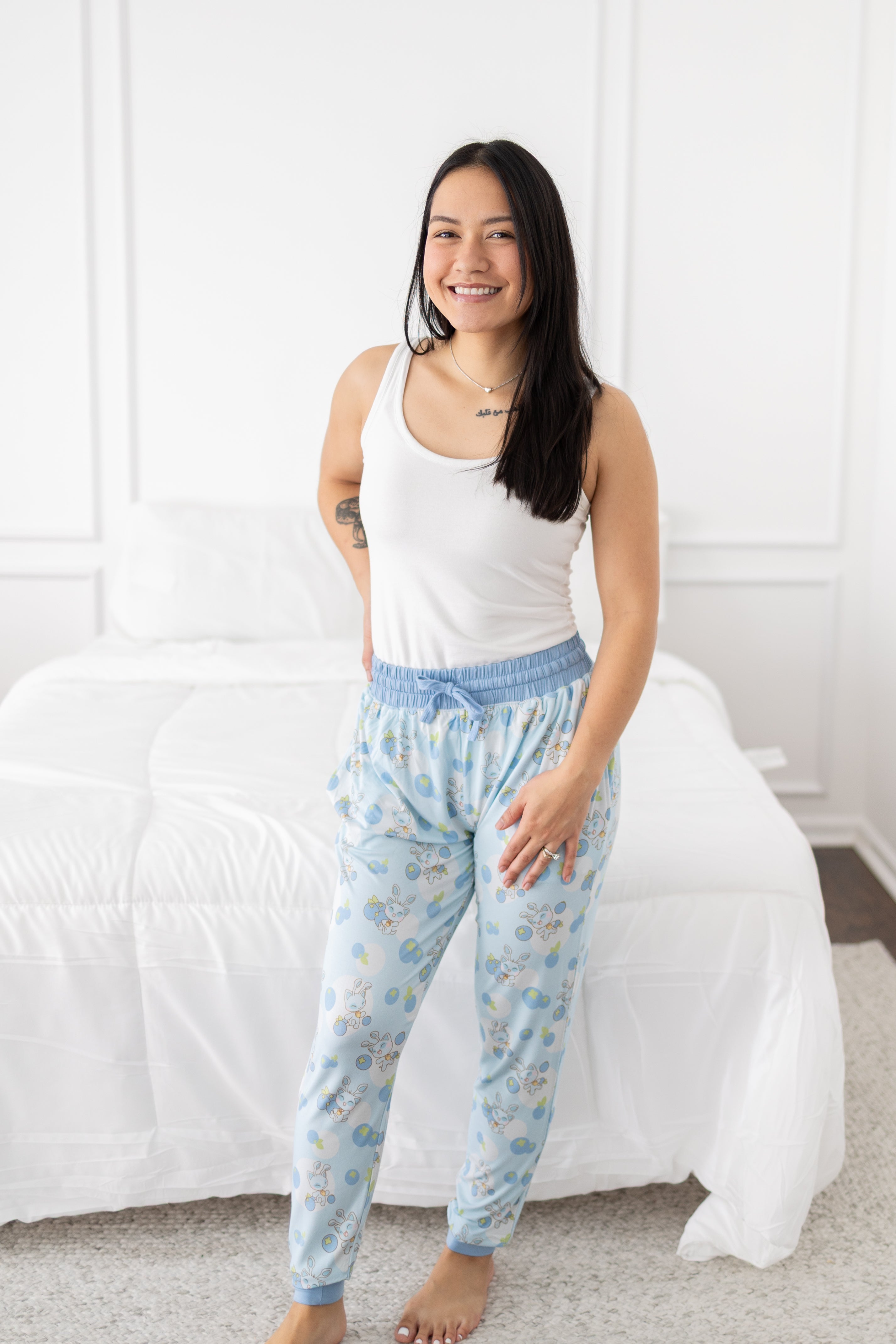 Women's light blue joggers with a Neopets blueberry baby print.