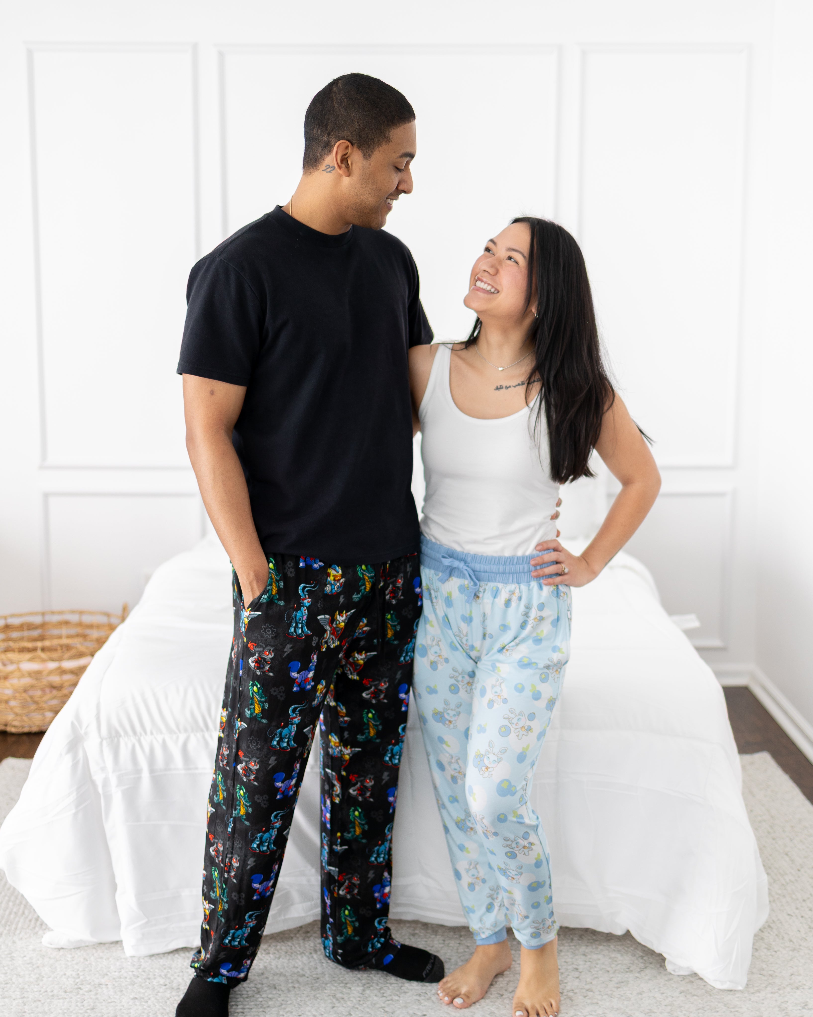 A couple poses in matching Neopets themed pajamas.