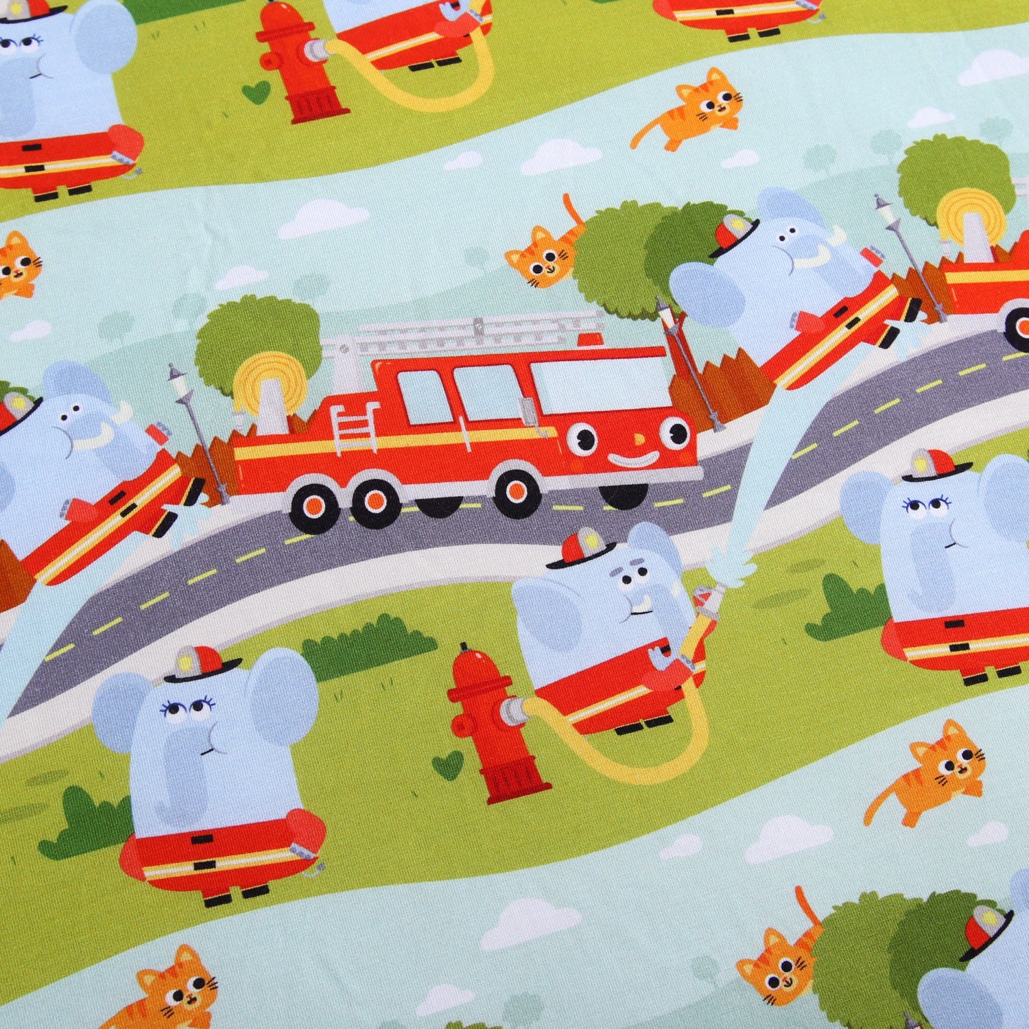 A playful fabric pattern with elephants, cats, and firetrucks.