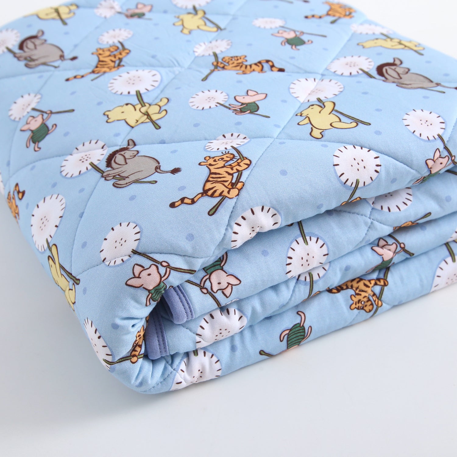A light blue quilted blanket