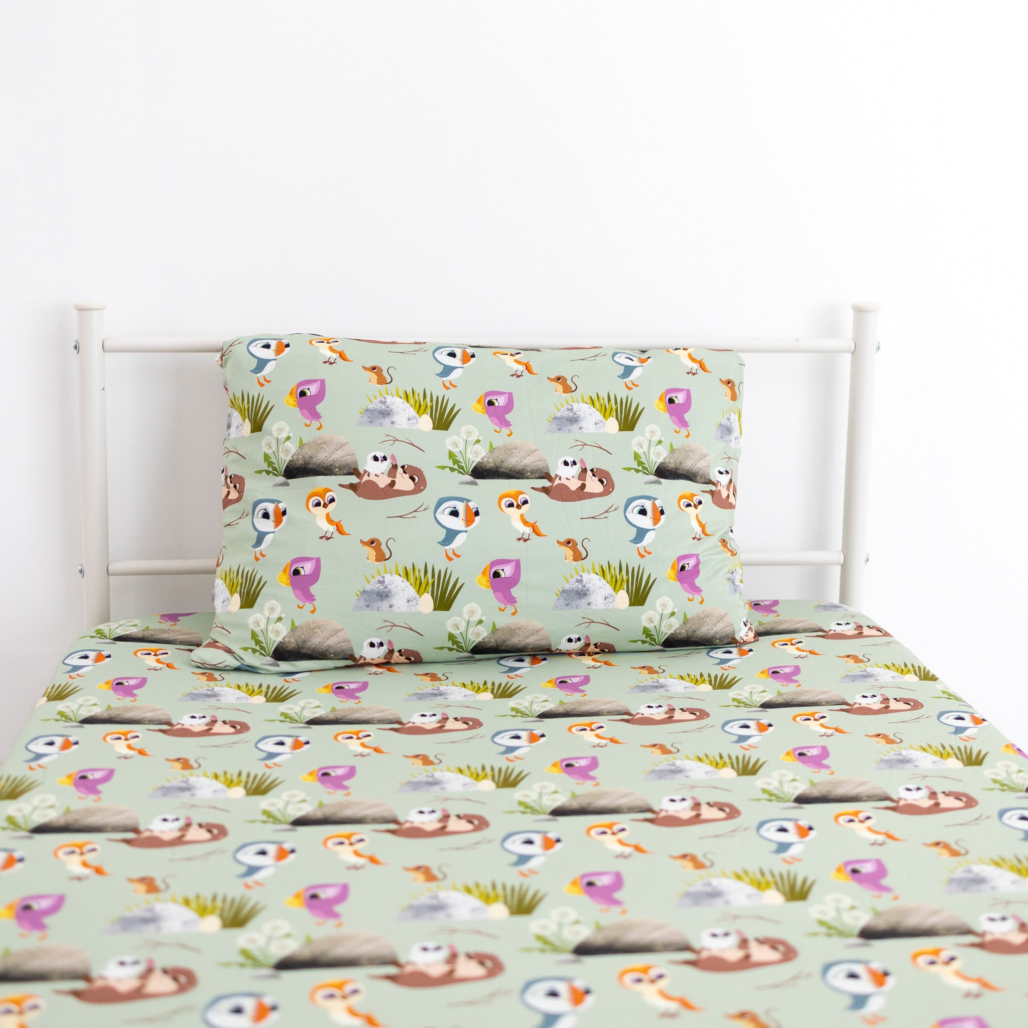 Puffin Rock twin sheet and pillow case set with a light green background and cartoon puffins and otters.