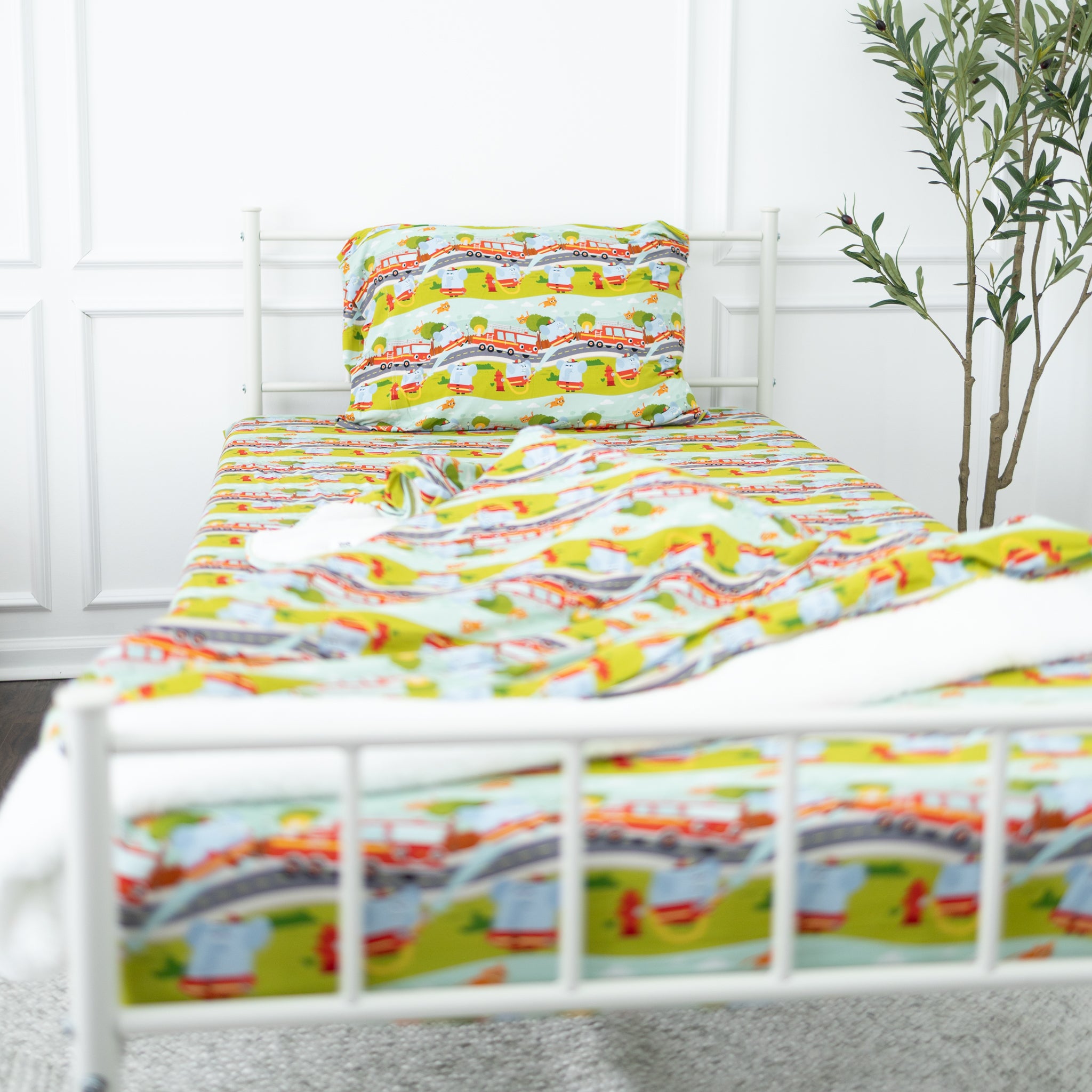 A twin fitted sheet and pillowcase set featuring a colorful firetruck and road pattern.