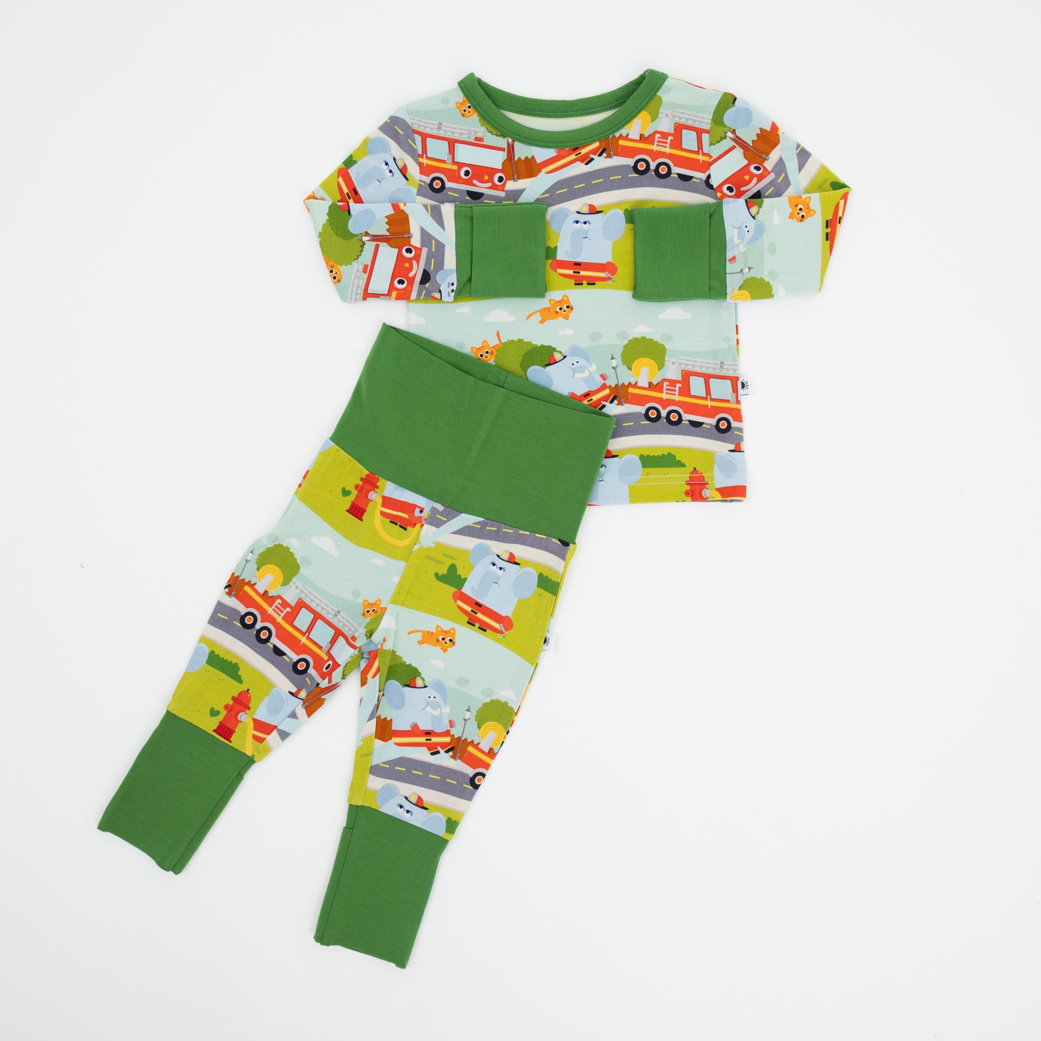 A long-sleeve shirt and pants set featuring a colorful firetruck and elephant print on light blue.