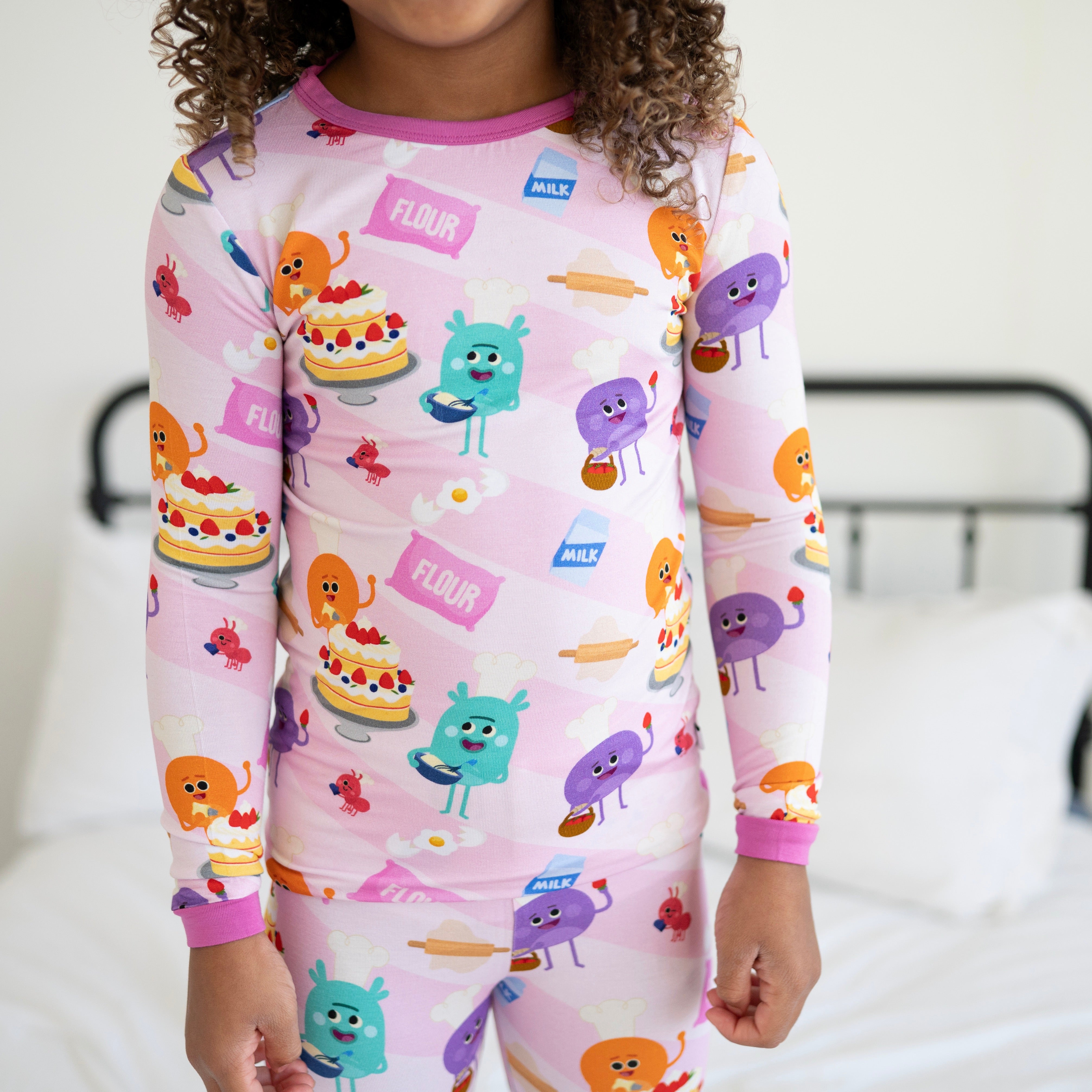 Pink long-sleeve pajamas with a baking-themed print.