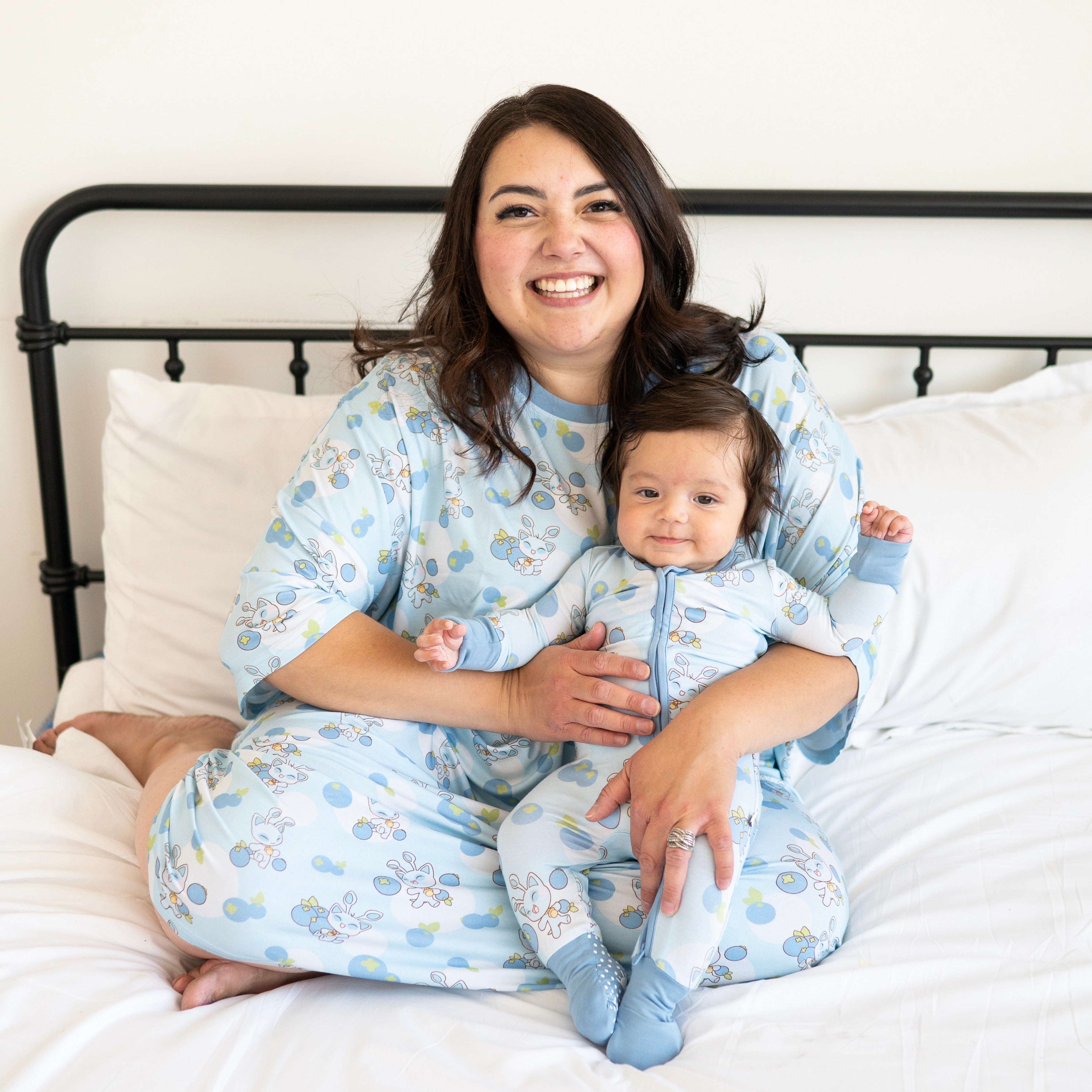 A woman and baby wear matching blue Neopets blueberry pajamas.