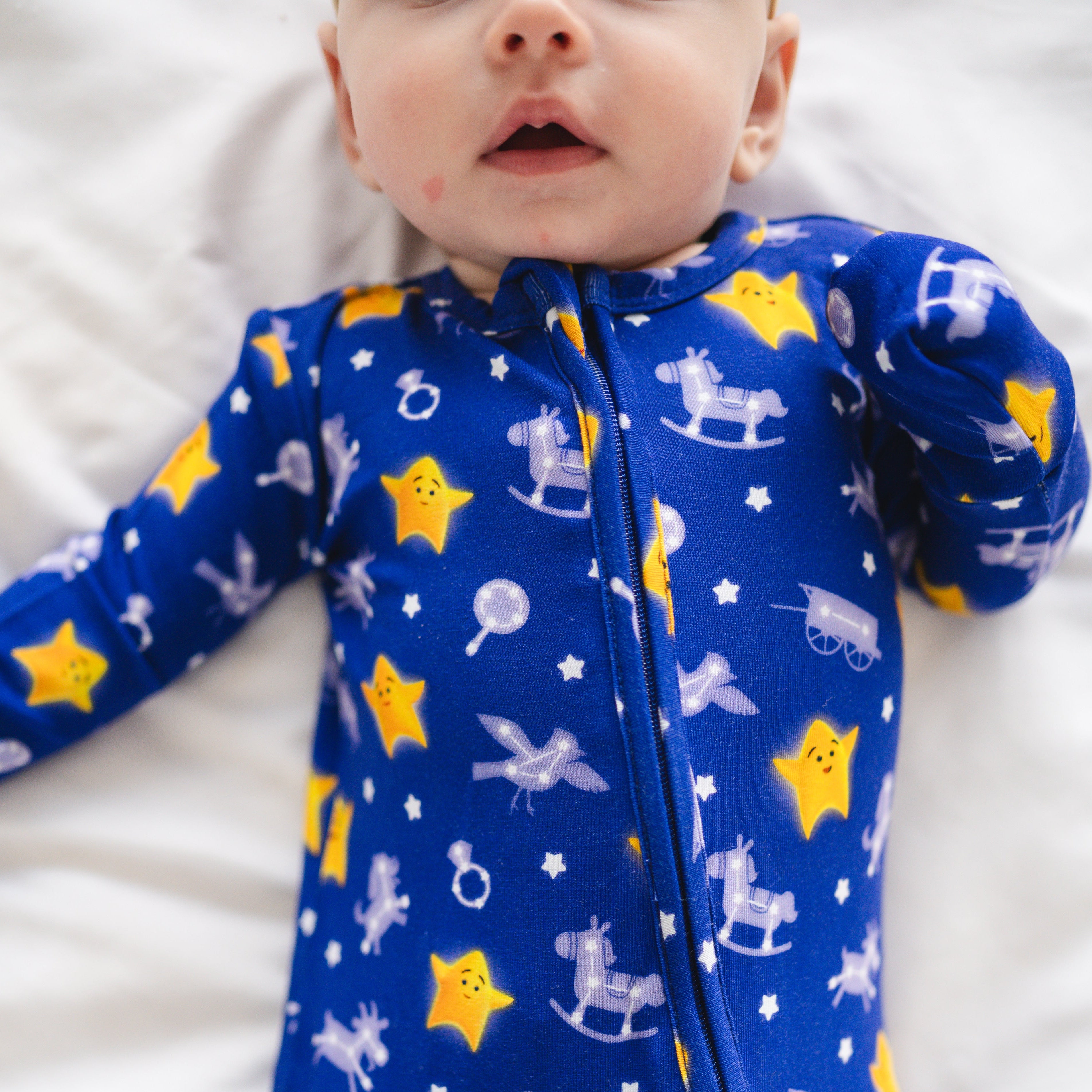 Blue bamboo pajamas with yellow stars and rocking horses.