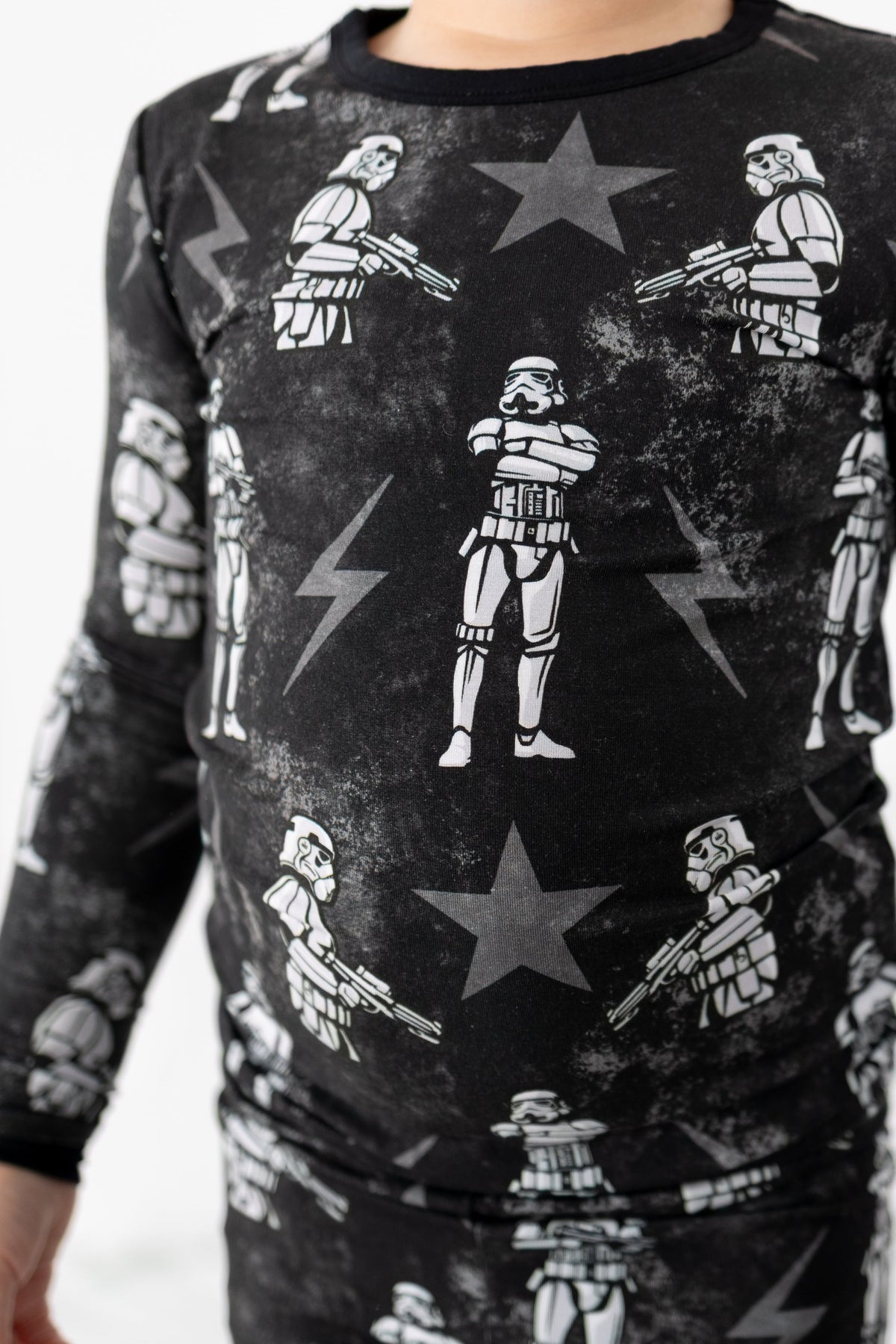 Black long sleeve pajamas with a repeating pattern of stormtroopers and stars.