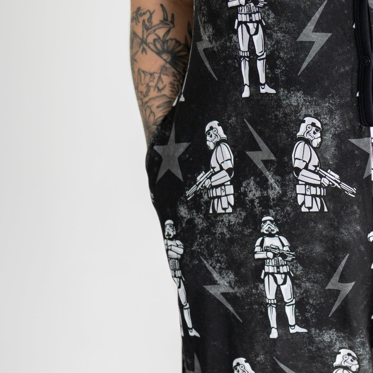 Black shorty romper with white stormtrooper print and lightning bolts.