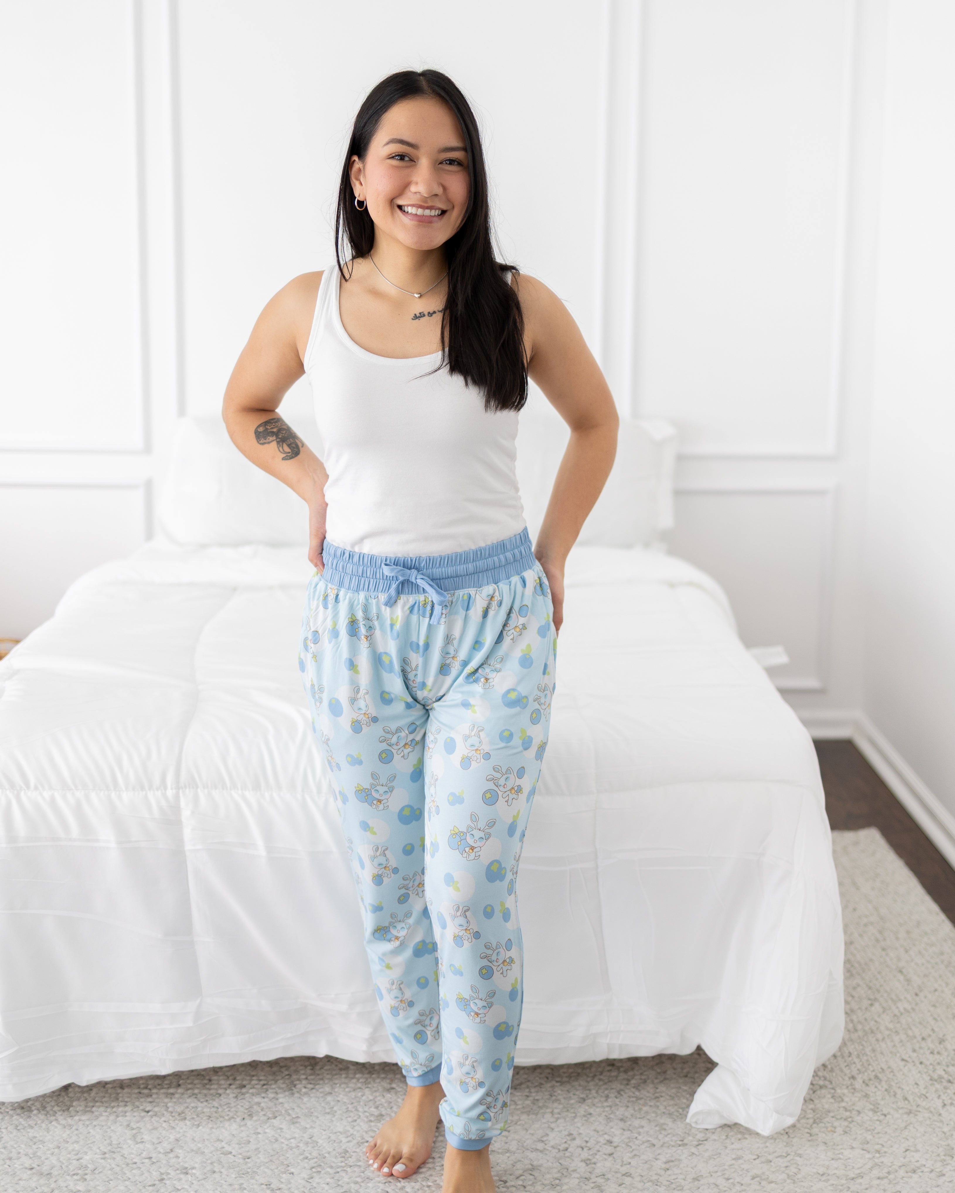Women's light blue Neopets blueberry baby print joggers with a white tank top.