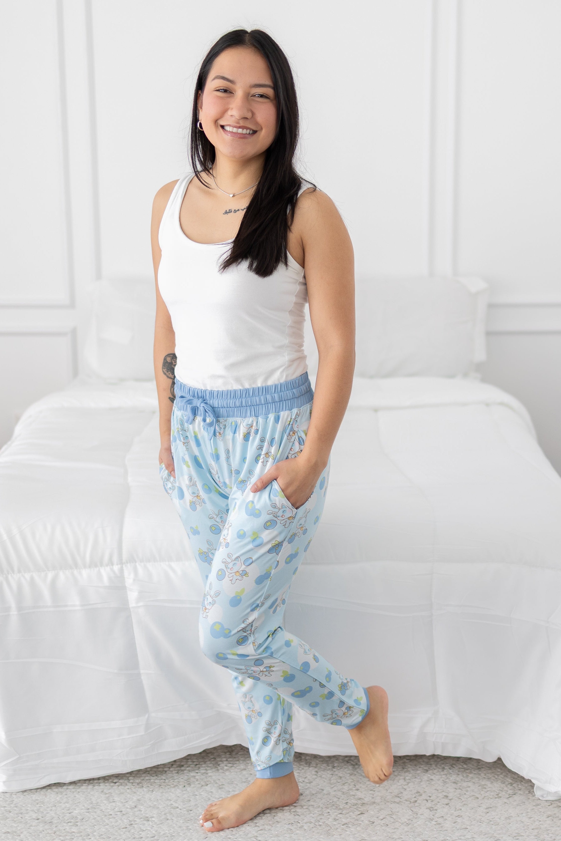 Women's light blue joggers with a blueberry and baby Aisha print.