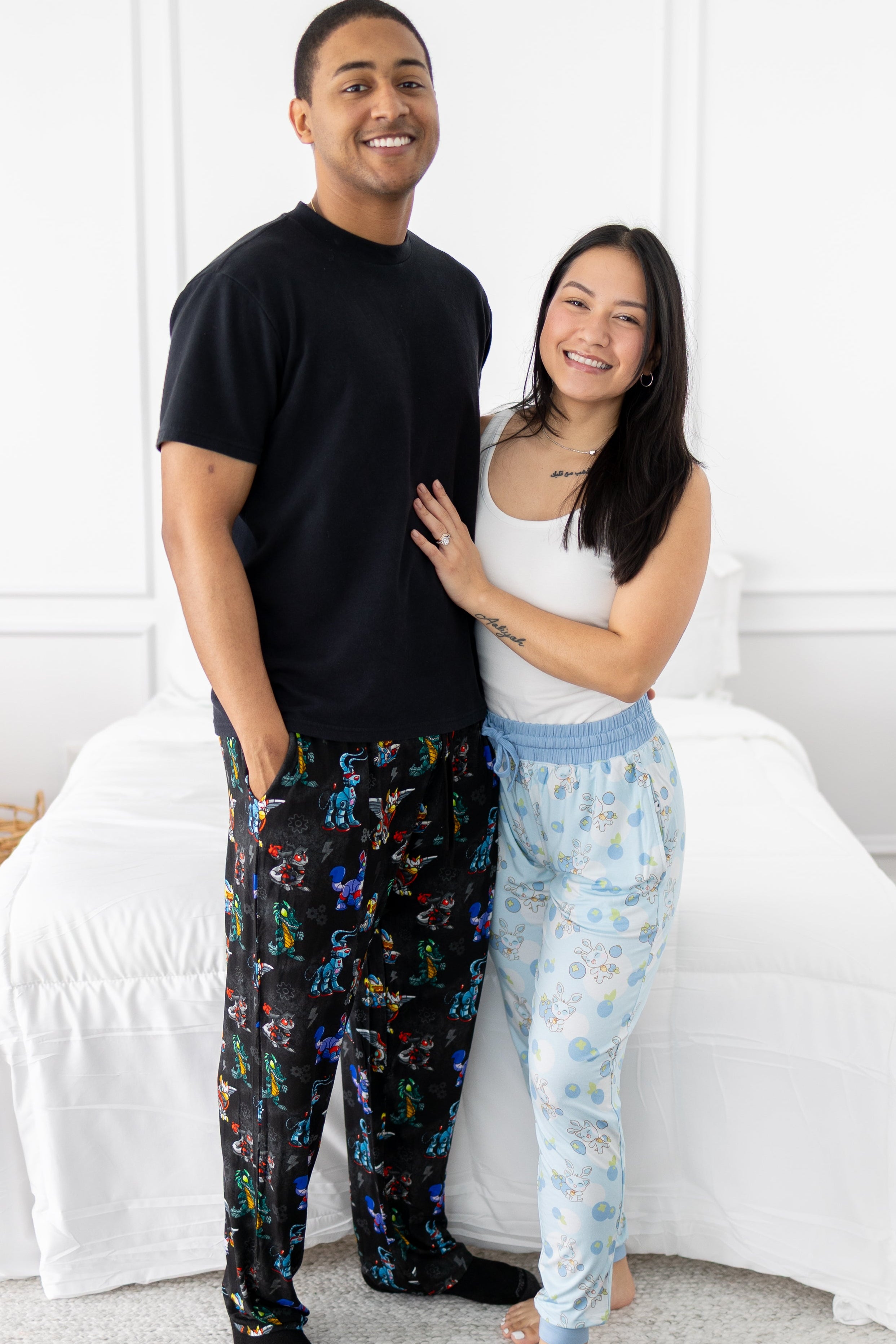 A couple poses in matching Neopets themed pajamas.