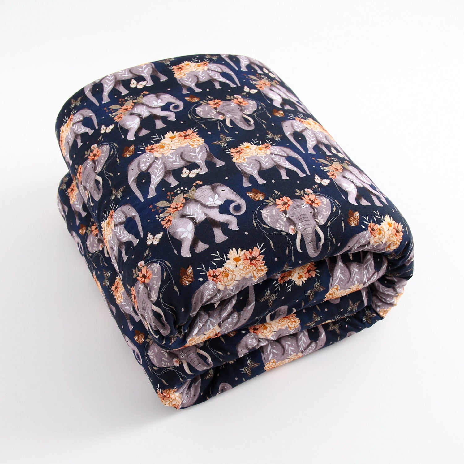 A folded navy blue blanket with a pattern of gray elephants and orange flowers.