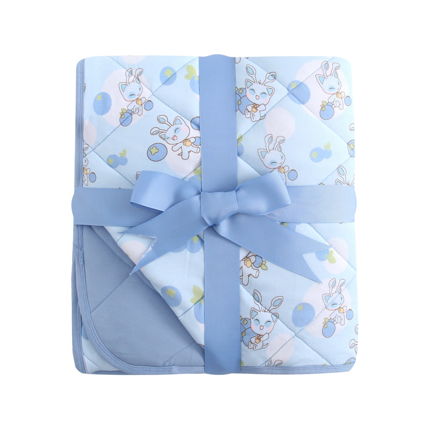 A blue quilted baby blanket with a blueberry and cat pattern, tied with a blue ribbon.