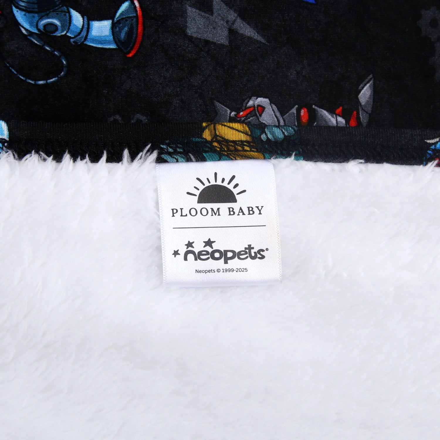 A plush blanket with a Neopets robot print and a white fuzzy underside.