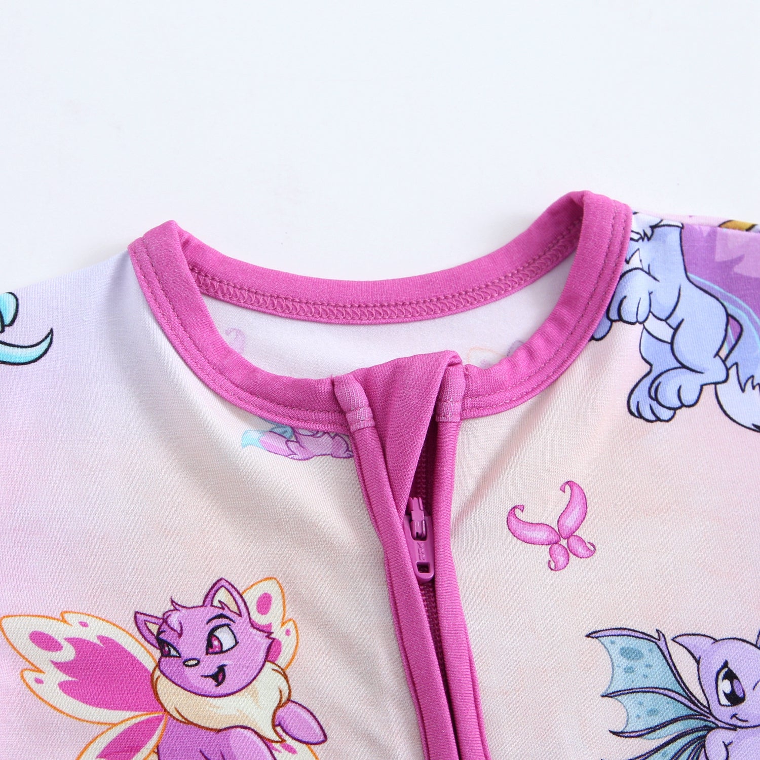 A pink zippered pajama top with Neopets faerie characters.