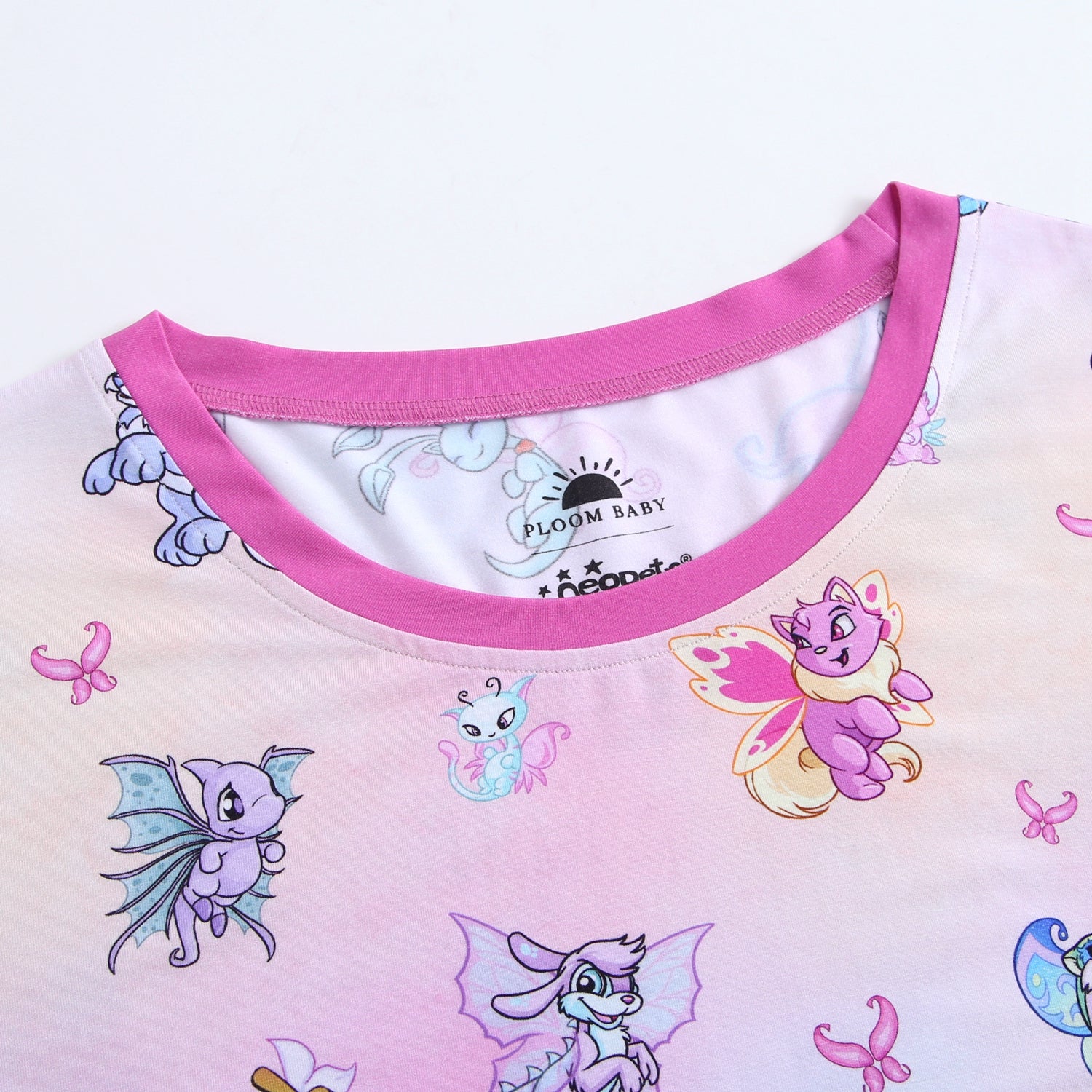 Adult t-shirt with a pink Neopets Faerie print and a pink neckline.
