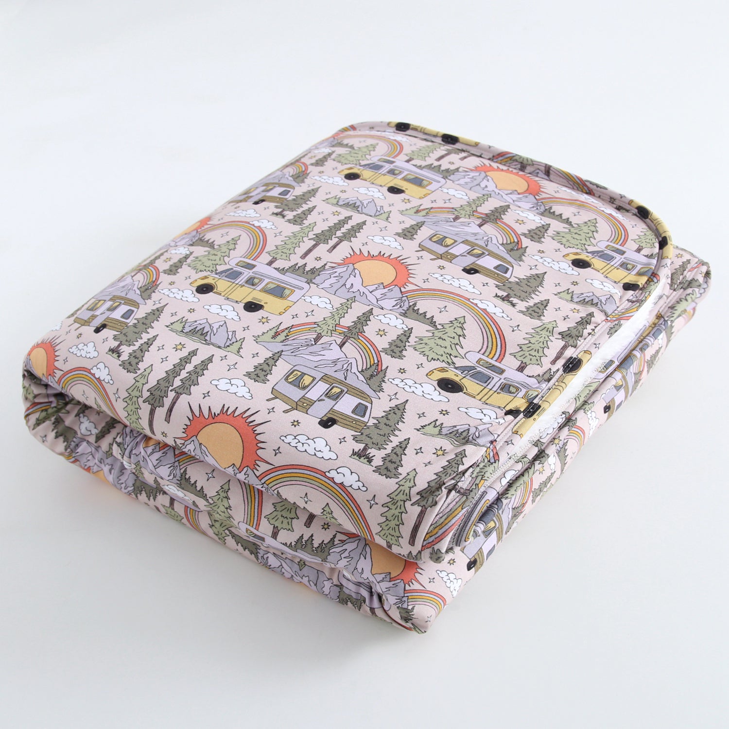 A plush blanket with a vintage camper, rainbow, and mountain pattern.
