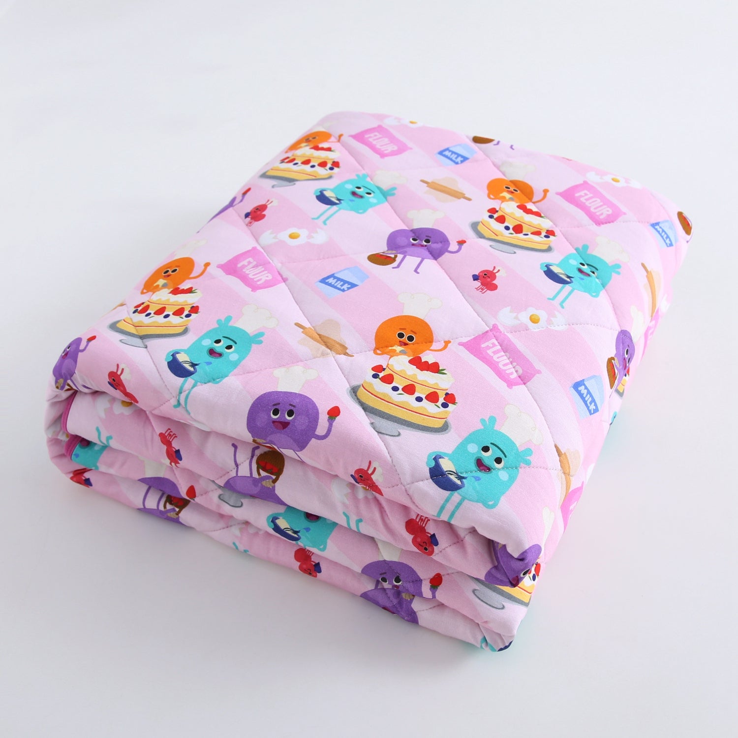 A pink quilted blanket with a cartoon baking theme.