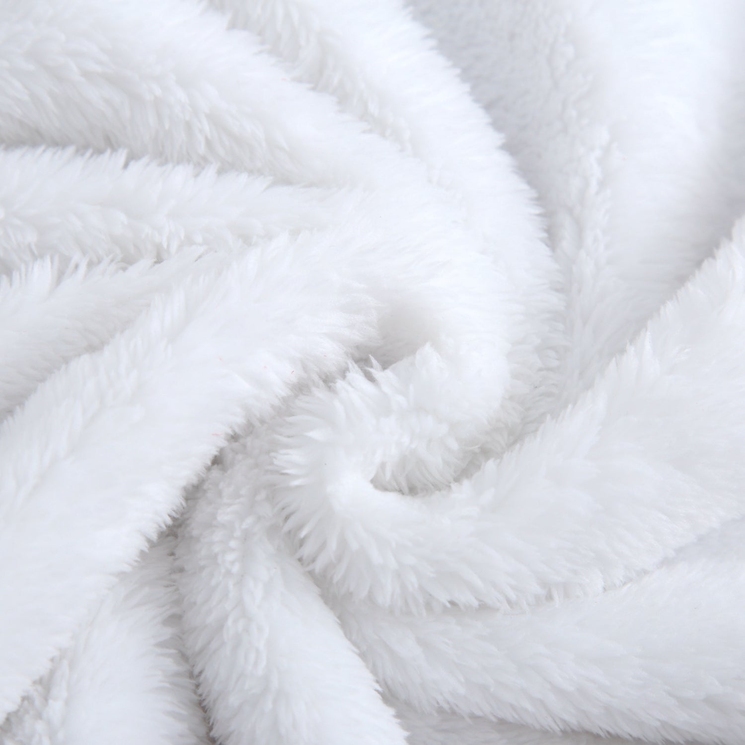 A white plush blanket with soft, swirling folds.