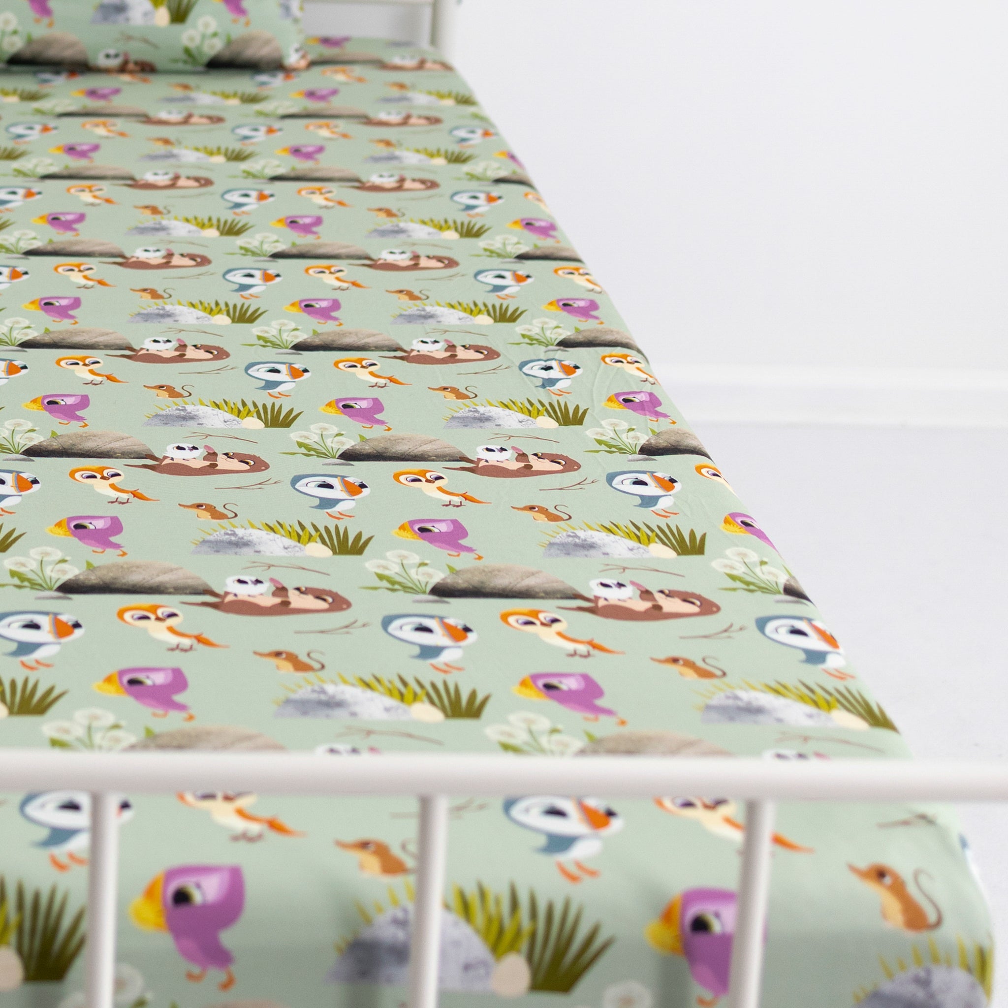 A light green twin sheet and pillowcase set with a Puffin Rock™ character print.