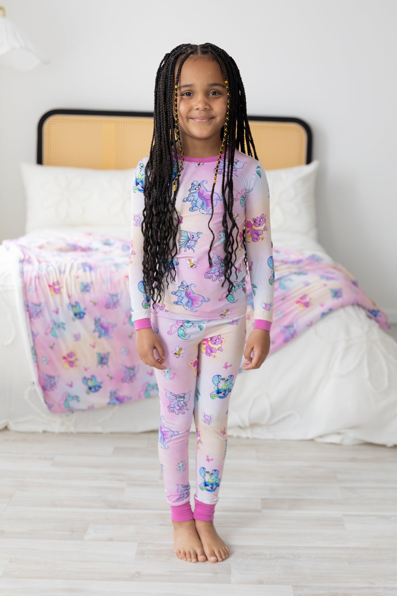 A young girl wears a long-sleeve Neopets Faerie print pajama set made of Tencel Modal fabric.
